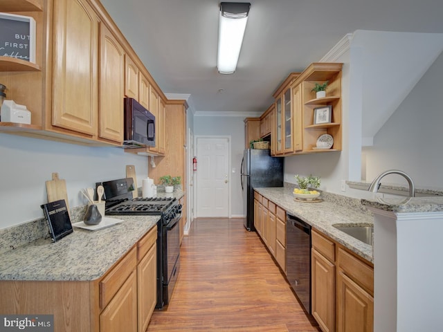 kitchen featuring black appliances, sink, crown molding, light stone countertops, and light hardwood / wood-style floors