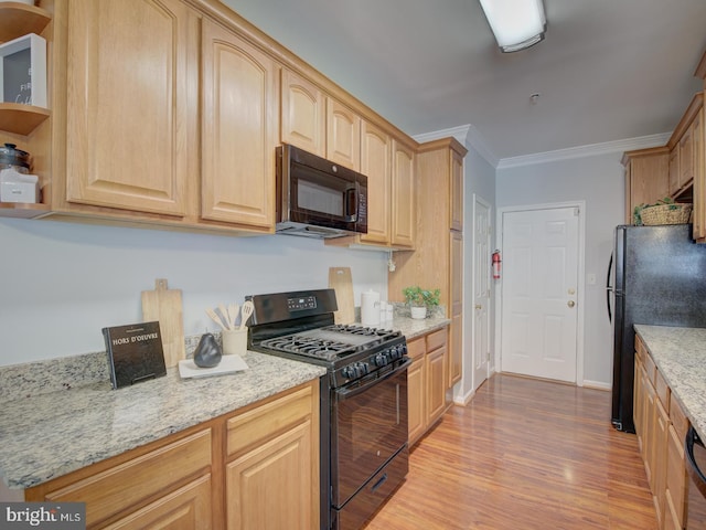 kitchen featuring light brown cabinets, black appliances, ornamental molding, light wood-type flooring, and light stone counters