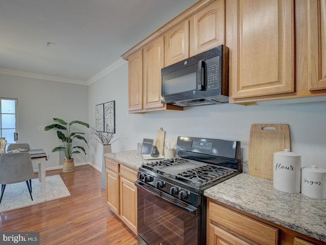 kitchen featuring light brown cabinets, ornamental molding, and black appliances