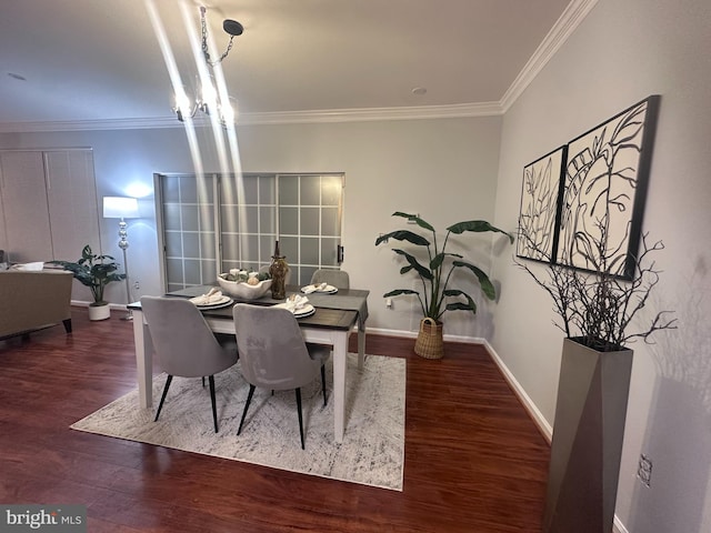 dining area with dark hardwood / wood-style flooring and ornamental molding