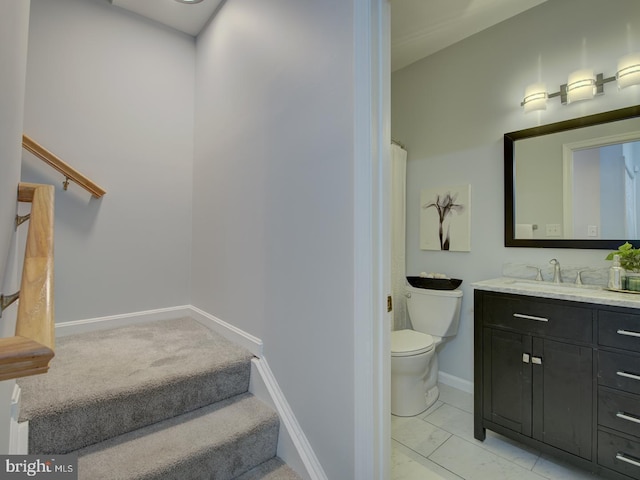 bathroom featuring tile patterned floors, vanity, and toilet