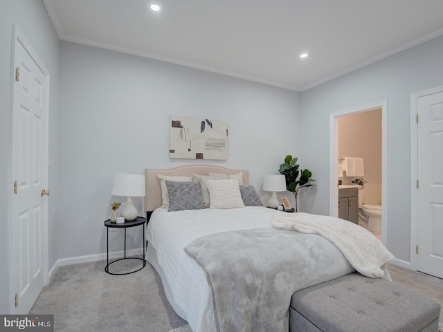 carpeted bedroom featuring ornamental molding and connected bathroom