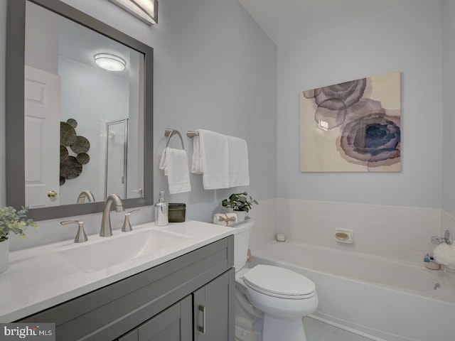 bathroom featuring a bathtub, vanity, and toilet