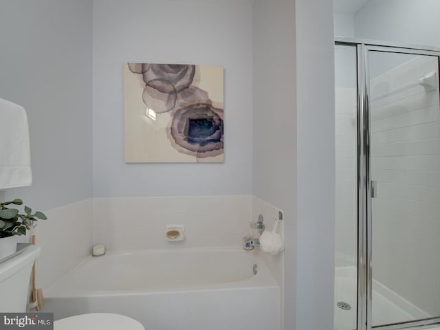 bathroom featuring separate shower and tub and toilet