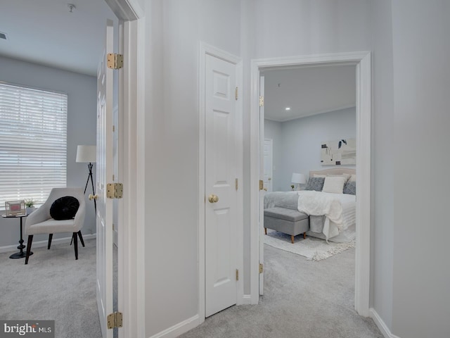 corridor with light colored carpet