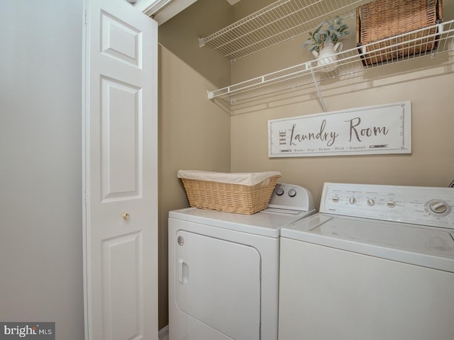 clothes washing area featuring washer and clothes dryer