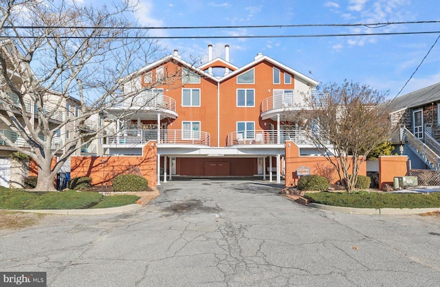 view of front facade featuring a balcony and a garage