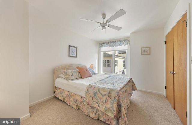 bedroom with ceiling fan and light carpet