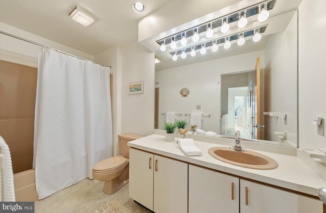 bathroom with vanity, toilet, and tile patterned flooring