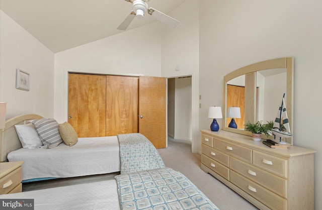 bedroom featuring a closet, ceiling fan, high vaulted ceiling, and light carpet