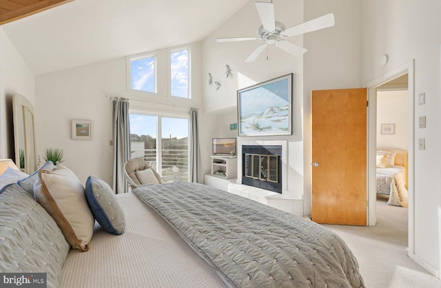 carpeted bedroom with a fireplace, high vaulted ceiling, and ceiling fan