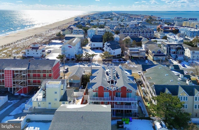 birds eye view of property featuring a beach view and a water view