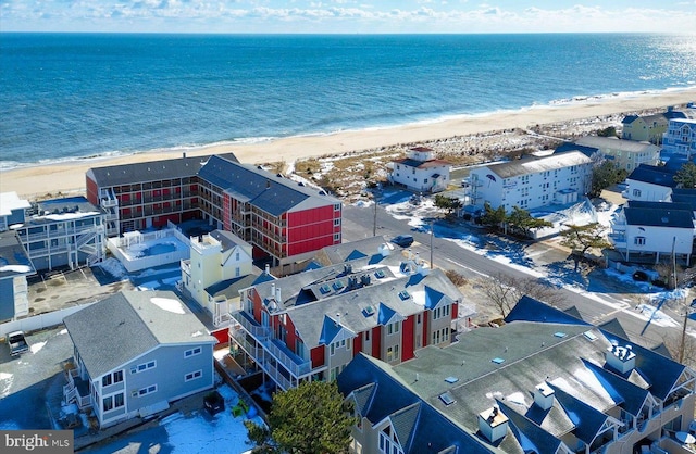 drone / aerial view featuring a water view and a beach view