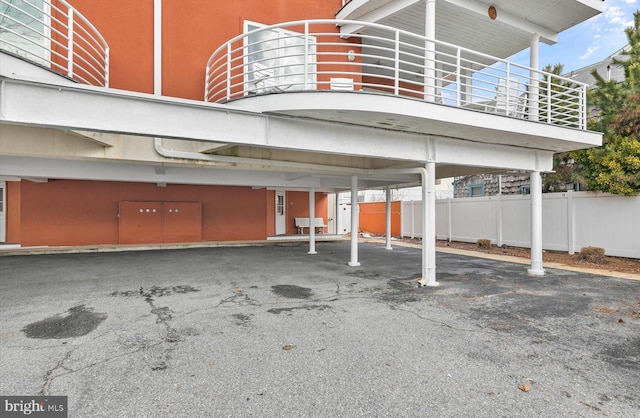 view of parking / parking lot featuring a carport