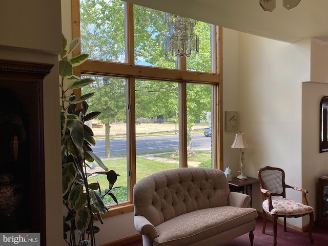 living area with a wealth of natural light and carpet