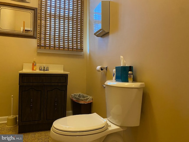 bathroom featuring tile patterned floors, vanity, and toilet