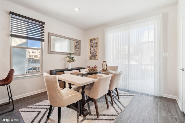 dining area with dark hardwood / wood-style floors