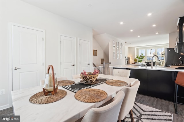 dining space with dark hardwood / wood-style flooring and sink