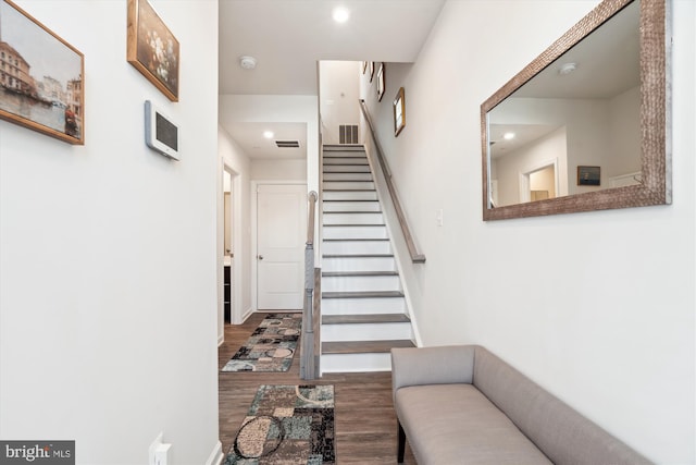 stairs featuring hardwood / wood-style floors