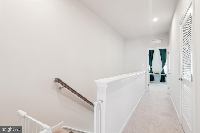 hallway with light colored carpet