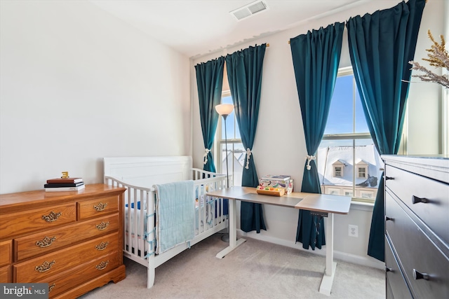 bedroom featuring light colored carpet and multiple windows