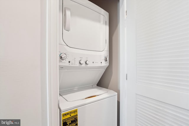 clothes washing area featuring stacked washer / dryer