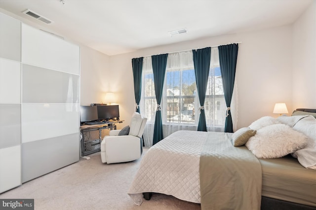 bedroom featuring light colored carpet