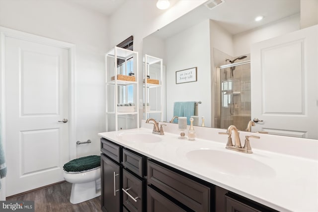 bathroom with vanity, hardwood / wood-style flooring, toilet, and an enclosed shower