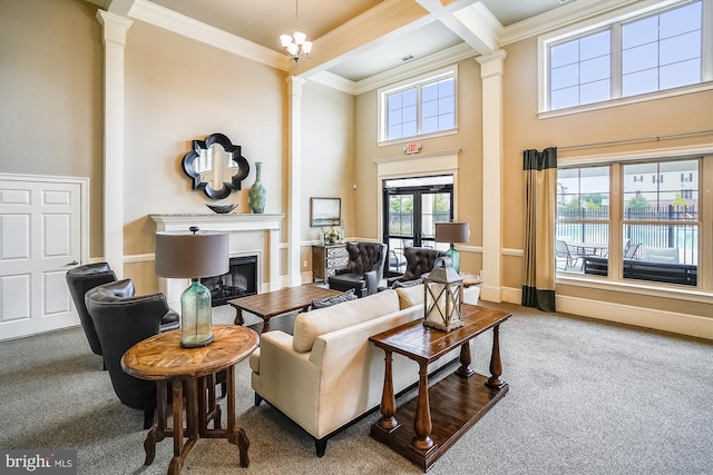 carpeted living room with french doors, decorative columns, crown molding, beam ceiling, and a chandelier