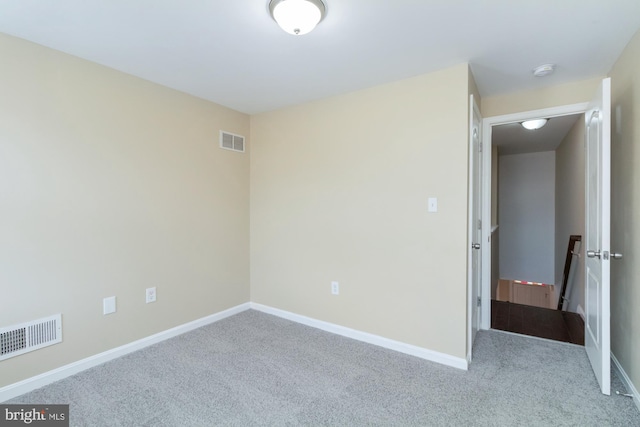 empty room featuring light colored carpet