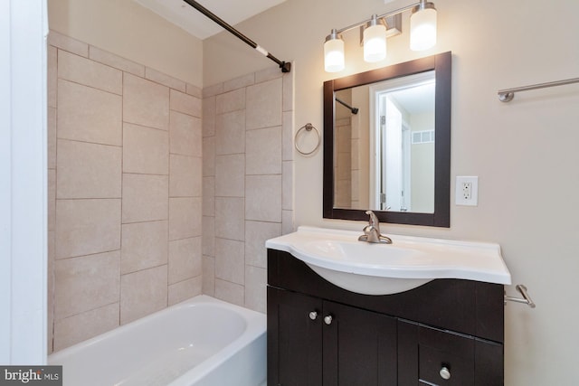 bathroom with vanity and tiled shower / bath combo