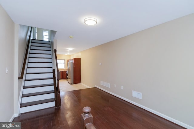 stairs featuring hardwood / wood-style floors