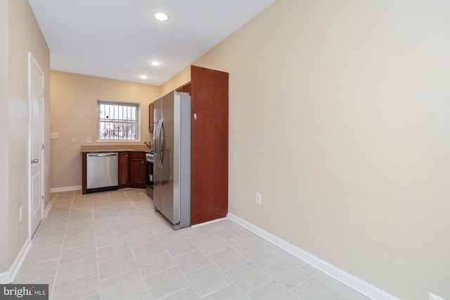 kitchen featuring stainless steel appliances and light tile patterned floors