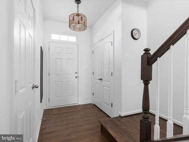 entrance foyer with a notable chandelier and dark hardwood / wood-style floors