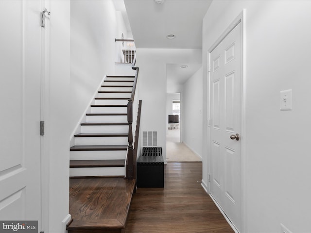 staircase with hardwood / wood-style flooring