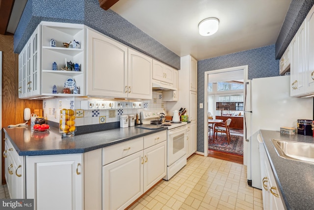 kitchen featuring backsplash, white appliances, white cabinets, and sink