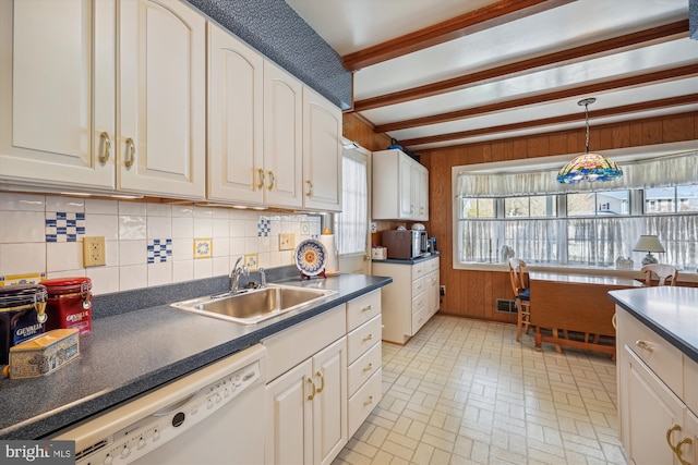 kitchen with pendant lighting, dishwasher, sink, white cabinets, and beam ceiling