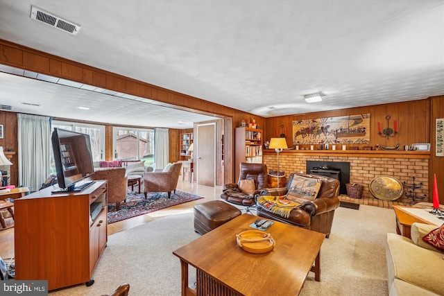 carpeted living room with wood walls and a fireplace