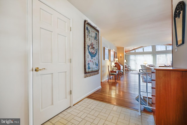 hallway with light hardwood / wood-style floors