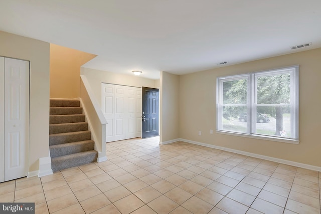 unfurnished room with light tile patterned floors