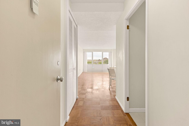 corridor with a textured ceiling