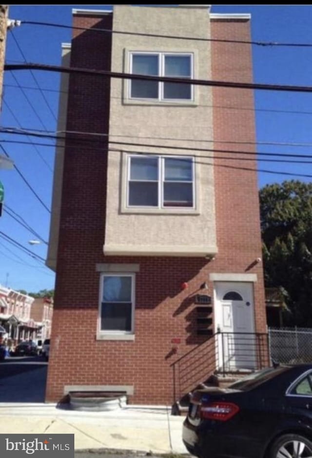 view of front of property with brick siding and stucco siding