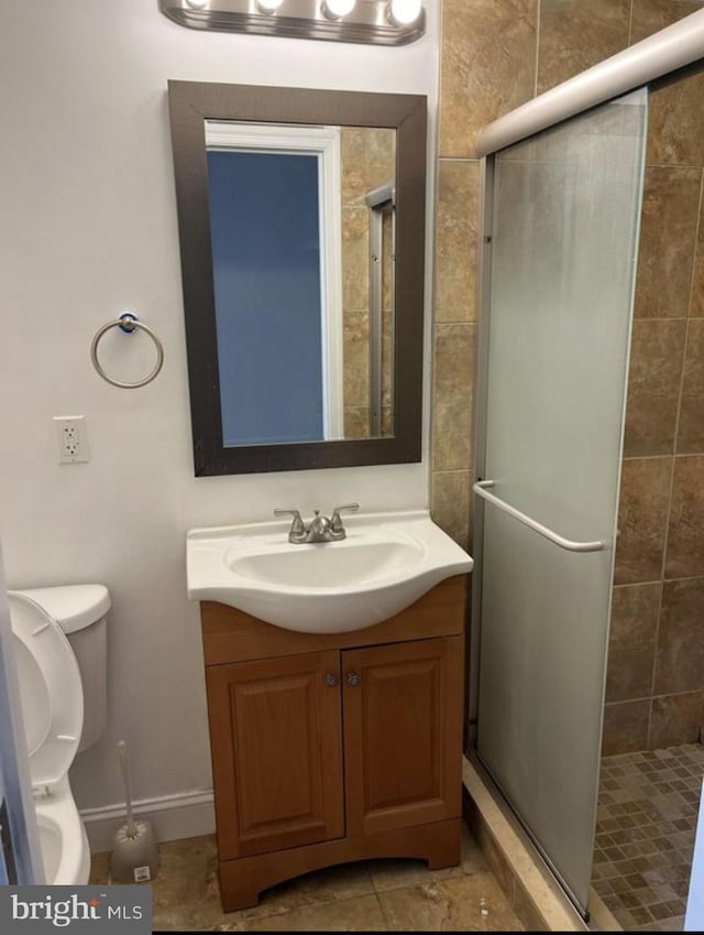 full bath with toilet, a shower stall, and vanity