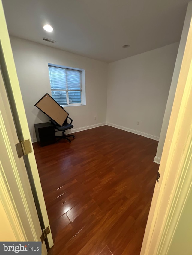 interior space featuring recessed lighting, dark wood finished floors, visible vents, and baseboards