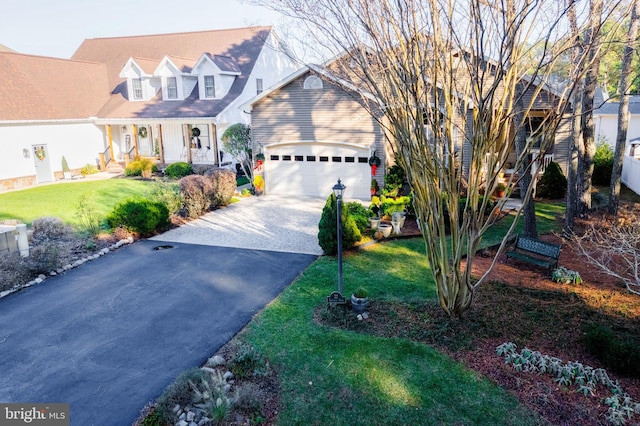 cape cod house with a garage and a front lawn