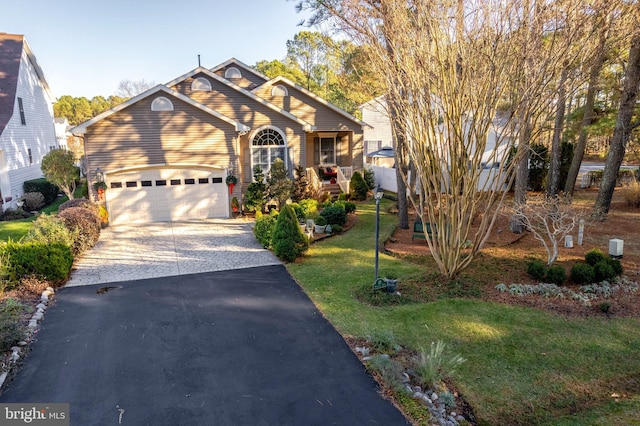 view of front of property featuring a garage and a front lawn