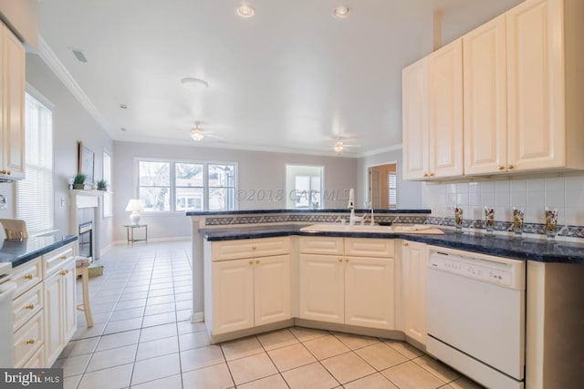 kitchen with kitchen peninsula, light tile patterned floors, white dishwasher, ornamental molding, and sink