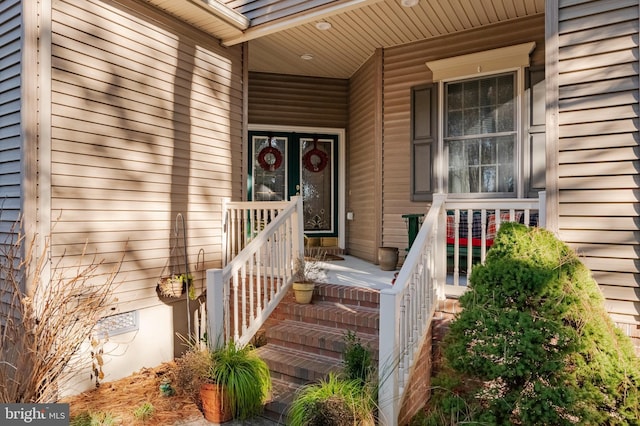 view of exterior entry featuring covered porch