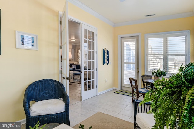 interior space with ornamental molding, french doors, and light tile patterned floors