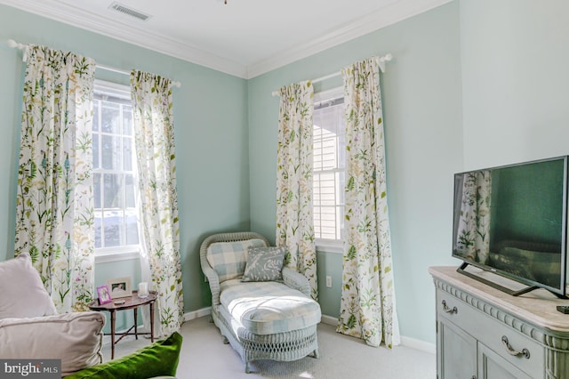 sitting room featuring a healthy amount of sunlight, crown molding, and light colored carpet